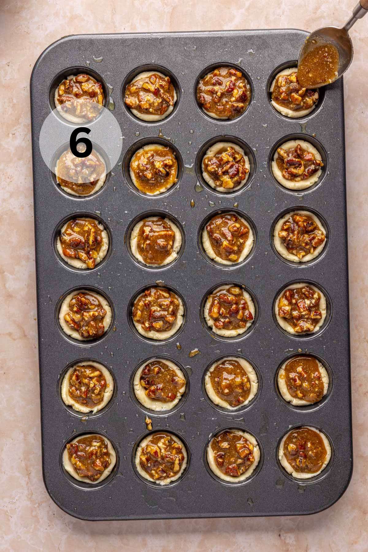 Spooning pecan pie filling into mini crusts.