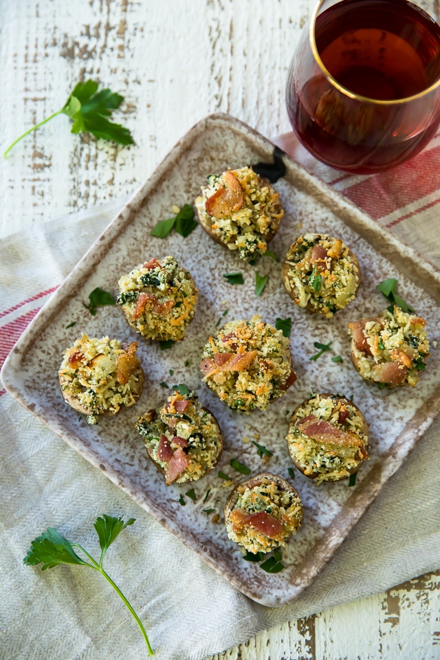 These Bacon Stuffed Mushrooms are the perfect app for your next party! Who doesn't love this cheesy and bacon filled deliciousness in the bite-sized perfection of mushroom caps?!