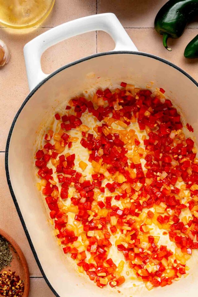 Cooked bell pepper, onion and garlic on a pot.