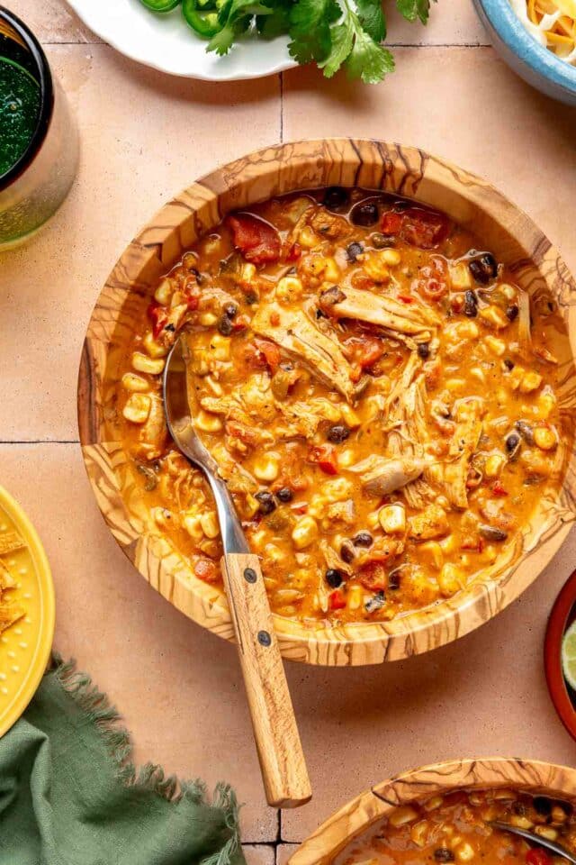 Chicken enchilada soup in a bowl with a spoon.