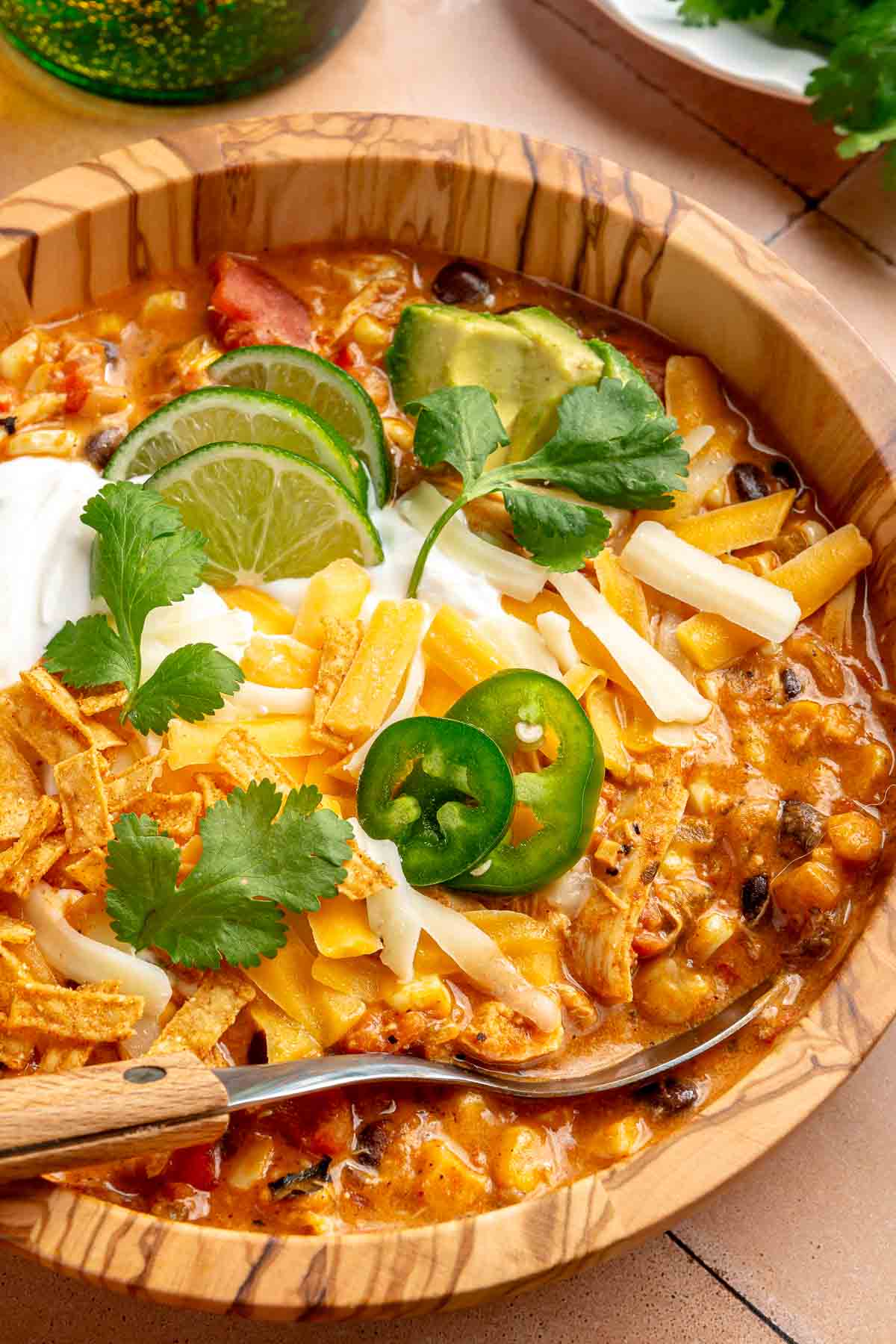 Soup with beans, corn and chicken, and topped with cheese, lime slices and jalapeños.
