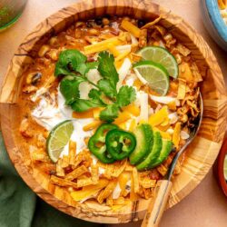 Chicken enchilada soup topped with sour cream, cilantro, jalapeños and lime.