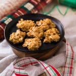 No Bake Peanut Butter Cookies on a black plate with Christmas wrapping paper and ribbon