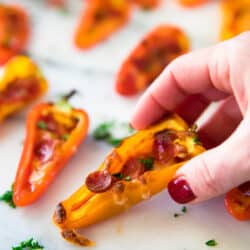hand-held Mini Pepper Pizzas picked up by woman's hand