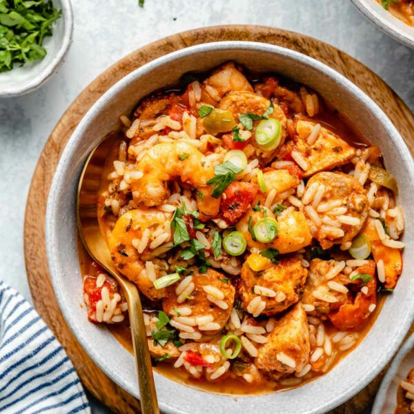 Jambalaya in a bowl garnished green onions.