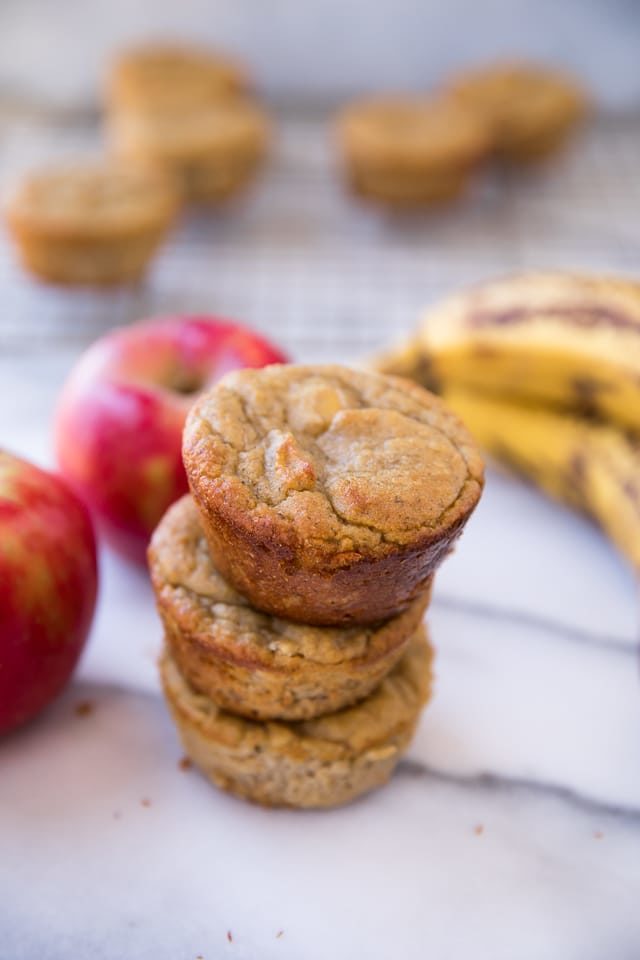 Flourless Banana Apple Muffins stacked up on a marble counter