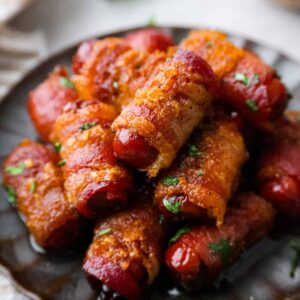 Bacon wrapped smokies on plate.