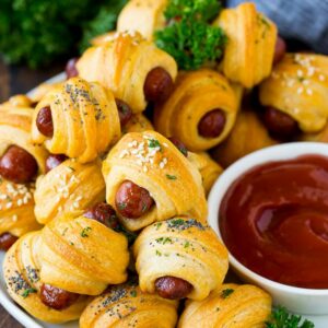 Pigs in a blanket served with ketchup.