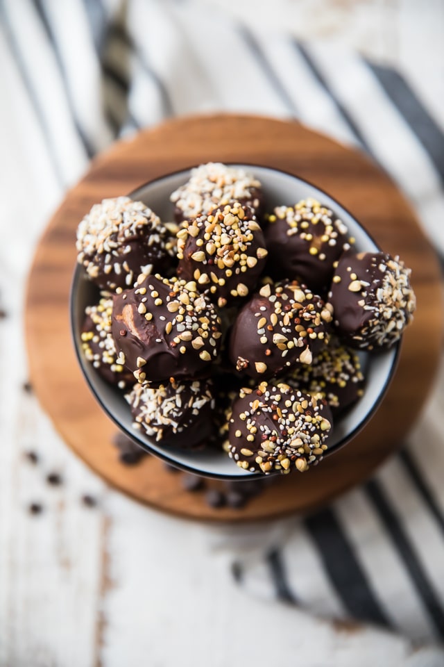 These healthy Chocolate Almond Butter Bites are a perfect treat for any party and a tasty option for those with peanut allergies. They seriously taste like a decadent dessert but are made with NO grains, eggs, or refined sugars. They’re gluten-free, vegan, and a healthy and delicious way to satisfy those chocolate cravings!