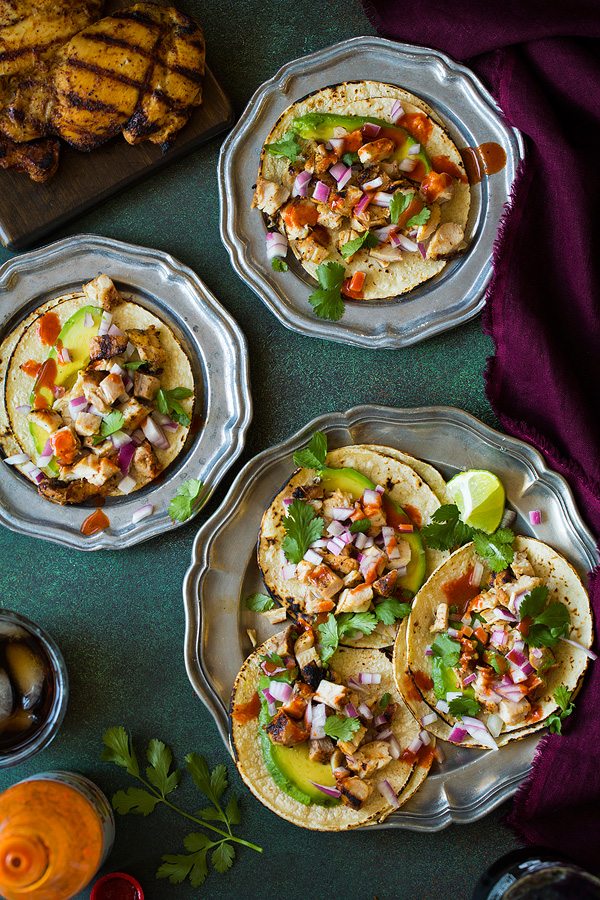 Marinated chicken thighs are grilled to perfection and served over mini corn tortillas with avocados, onions and cilantro. Easy to make and so delicious!