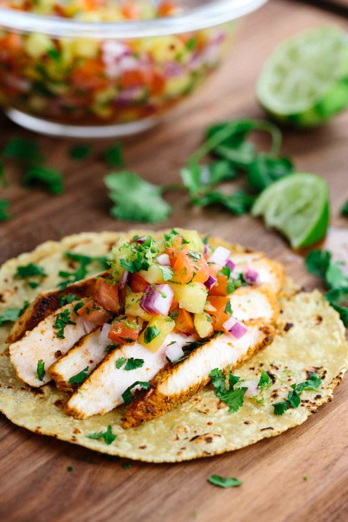 Blackened chicken tacos with pineapple salsa recipe will make any day feel like a fiesta! Healthy chicken breast is marinated in savory spices and herbs.