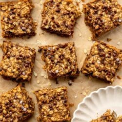 Oatmeal bars with chocolate chips on parchment paper.