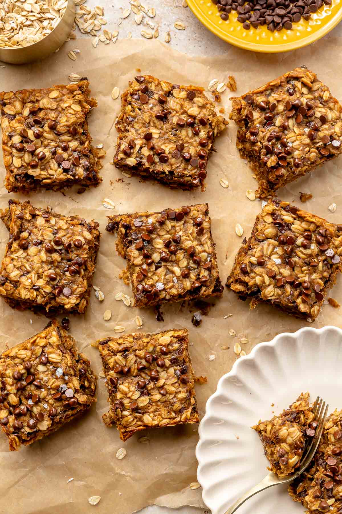Oatmeal bars with chocolate chips on parchment paper.