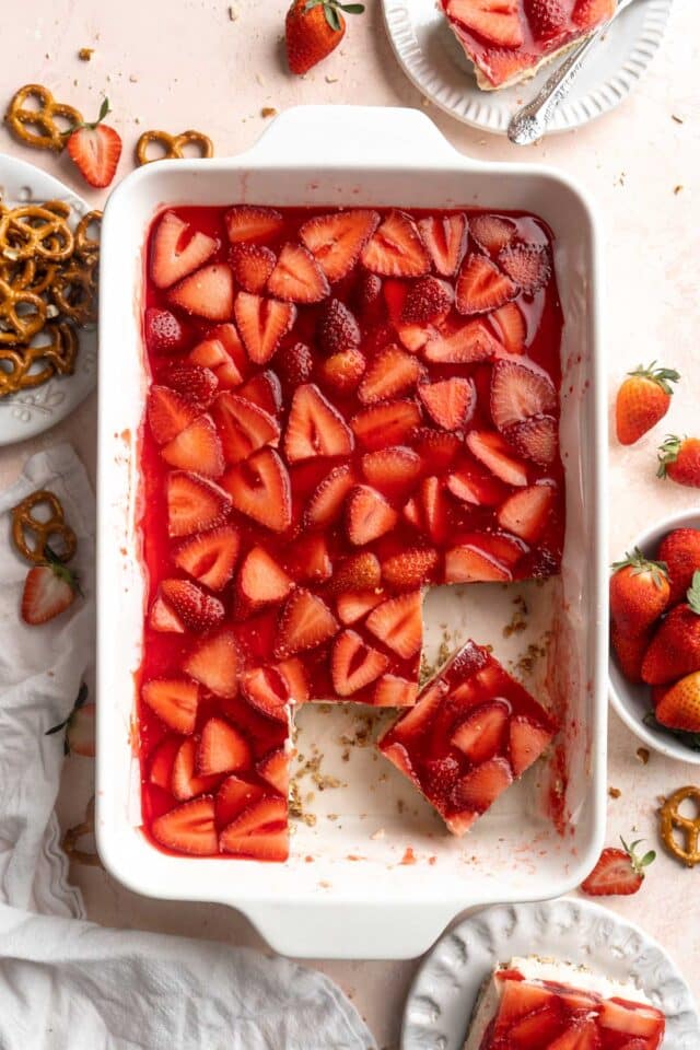 Pieces of strawberry pretzel dessert cut in a white dish.
