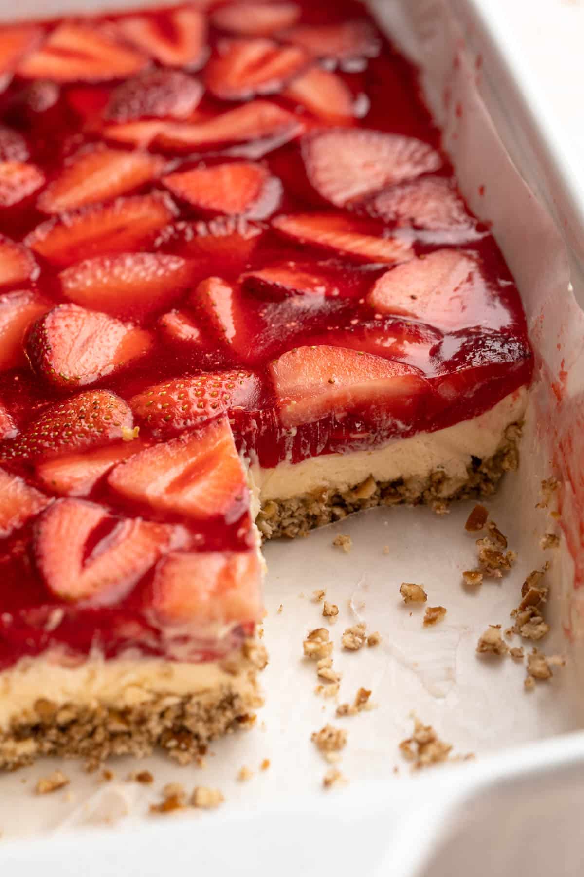 Strawberry pretzel dessert with slices missing out of the pan.