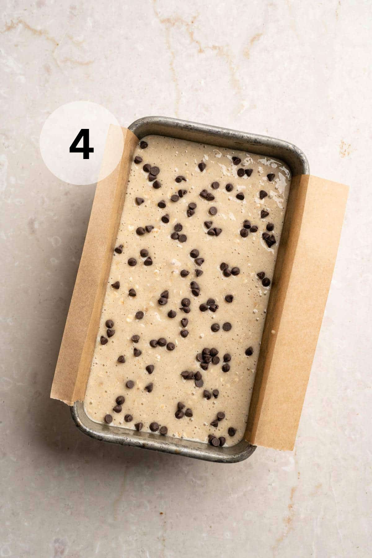 Banana bread batter in a loaf pan.