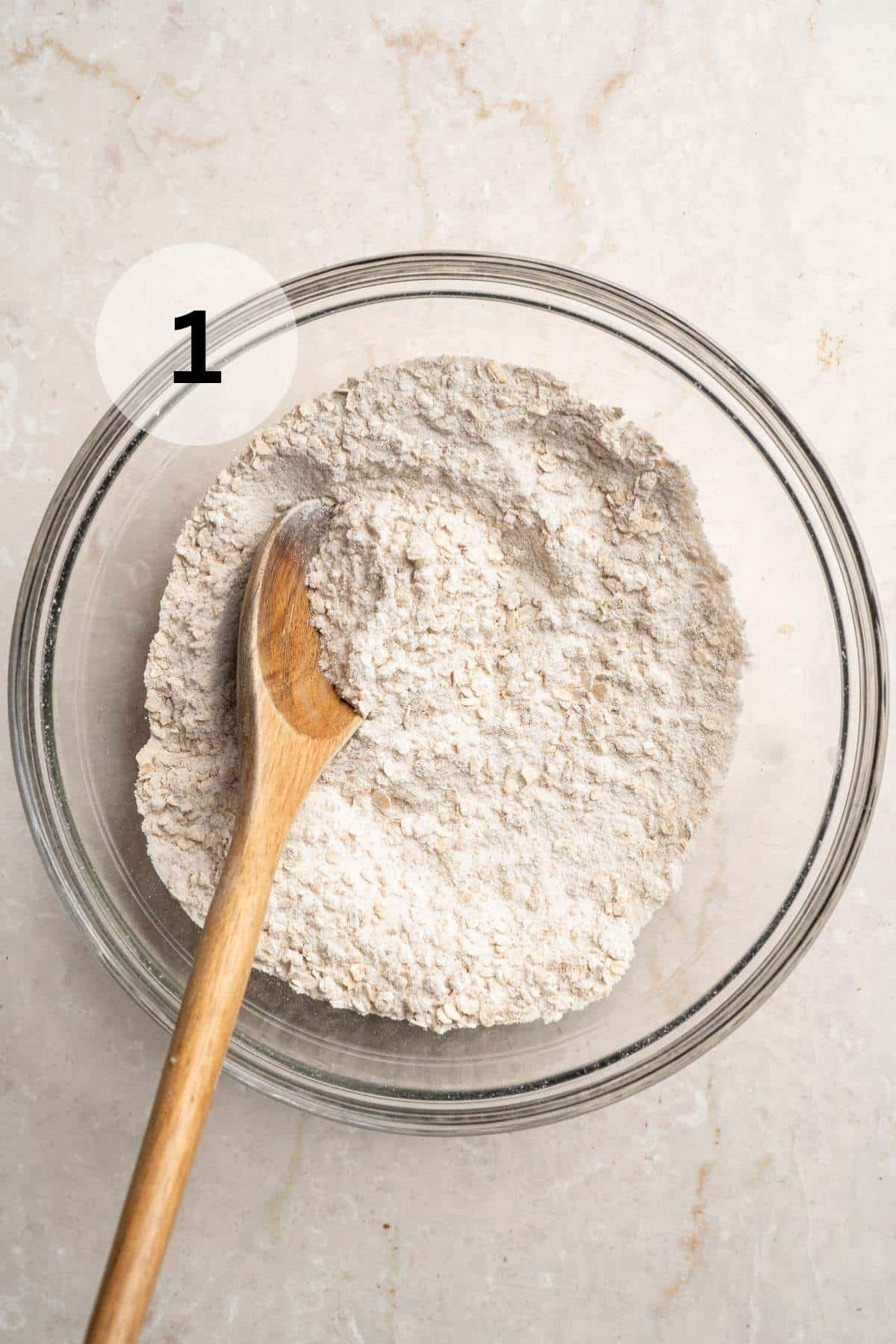 Stirring flour mixture with a wooden spoon.
