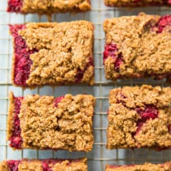 overhead view of Raspberry Almond Oat Bars on gold wire cooling rack