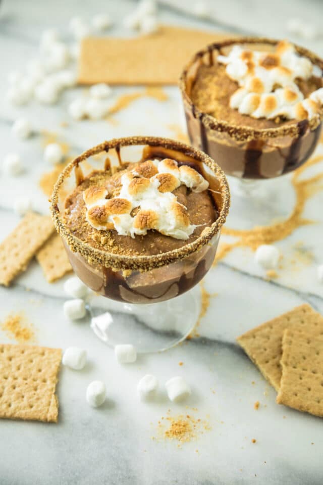 Skinny S'mores Protein Shake in a glass with graham crackers and marshmallows