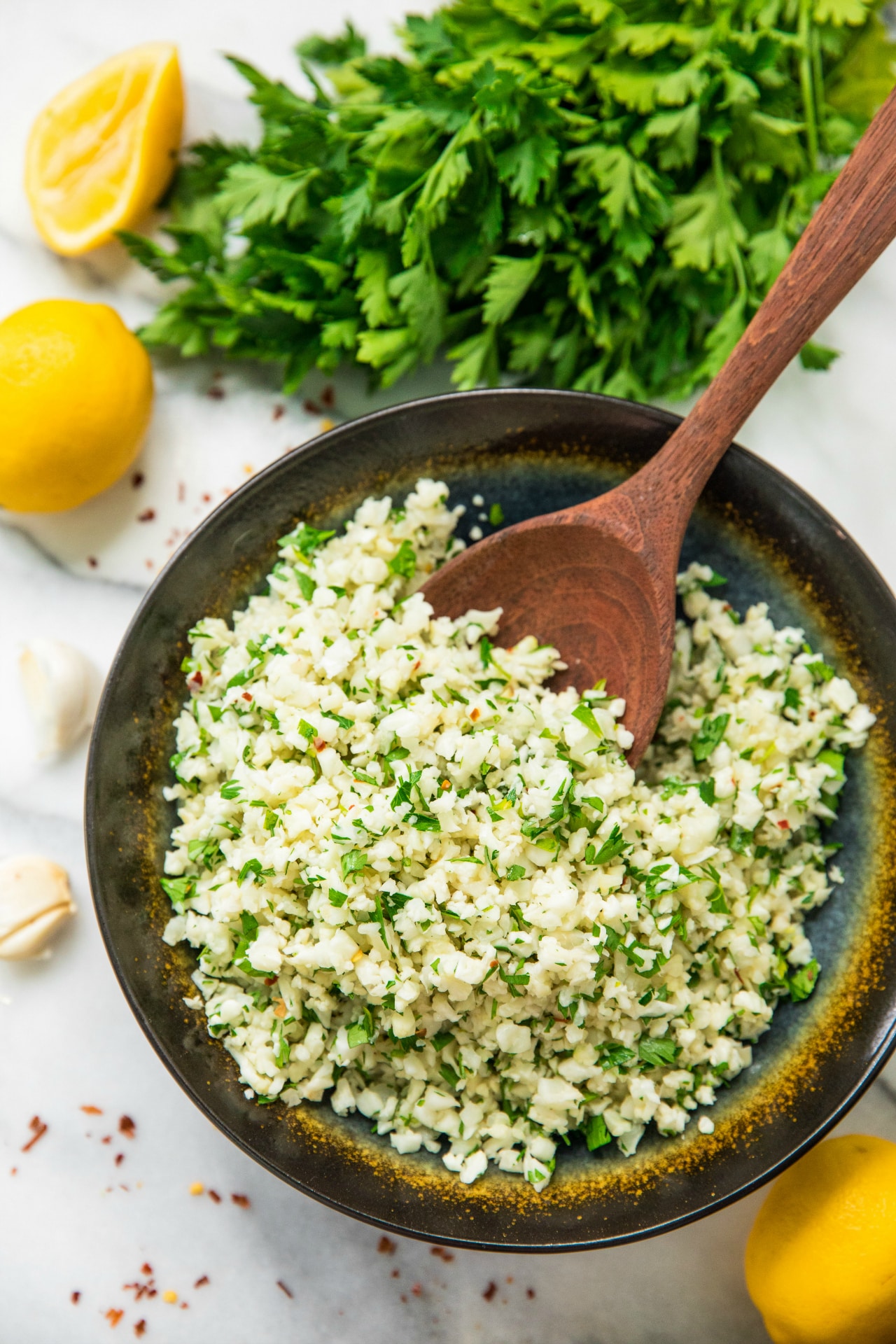 LOVE this easy to make Simple Lemon Parsley Cauliflower Rice!! Add some roasted salmon or grilled chicken on top and you have a wholesome, flavorful, and delicious gluten free meal!