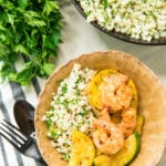Easy Shrimp Zucchini Squash Skillet served in a tan bowl over cauliflower rice