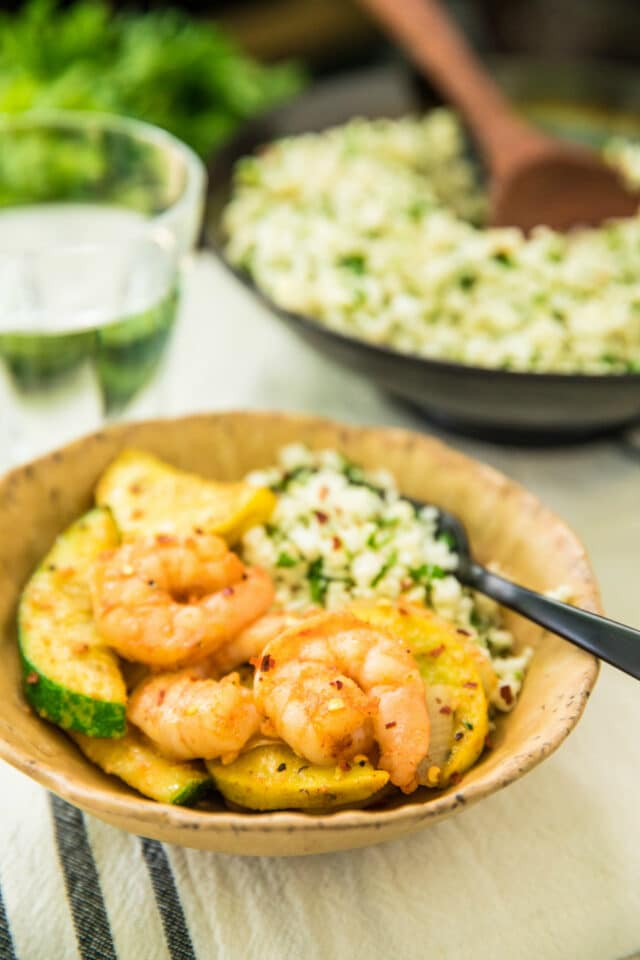 Easy Shrimp Zucchini Squash Skillet in a bowl with cauliflower rice