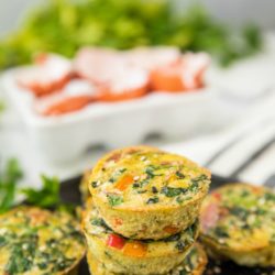 Healthy Sweet Potato Spinach Egg Cups stacked on a black plate