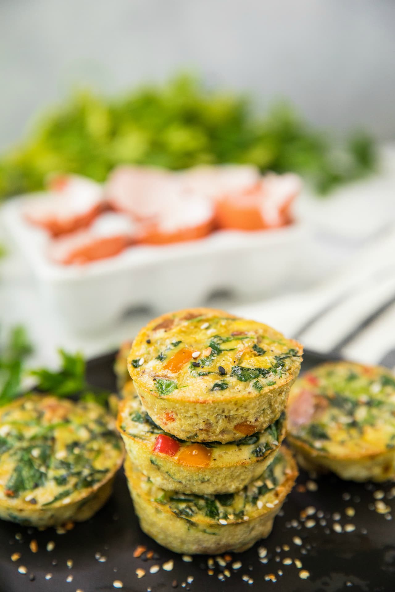 Healthy Sweet Potato Spinach Egg Cups stacked on a black plate
