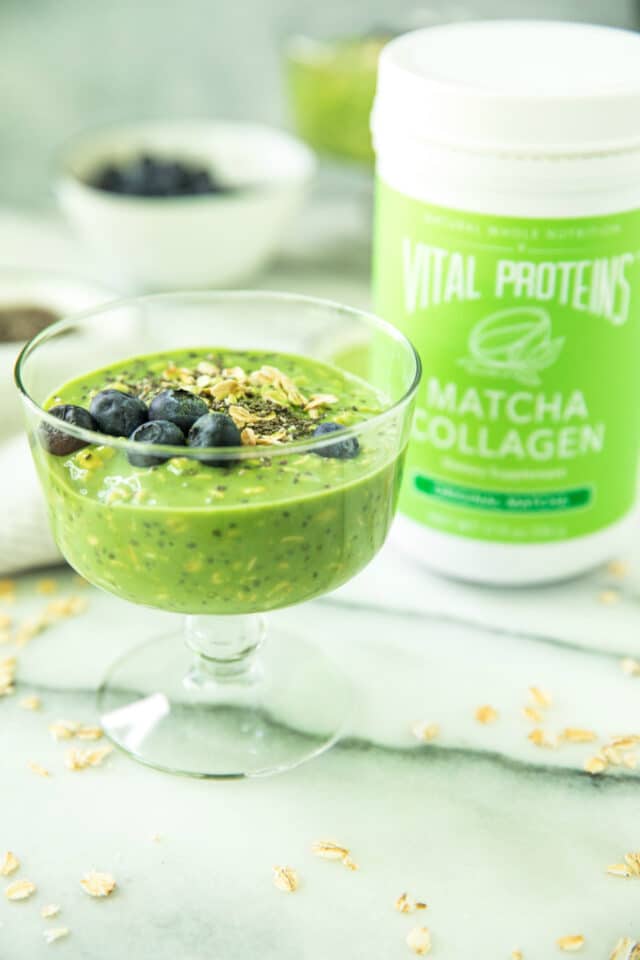 Matcha Collagen Overnight Oats in a glass sitting next to a canister of Vital Proteins Matcha Collagen
