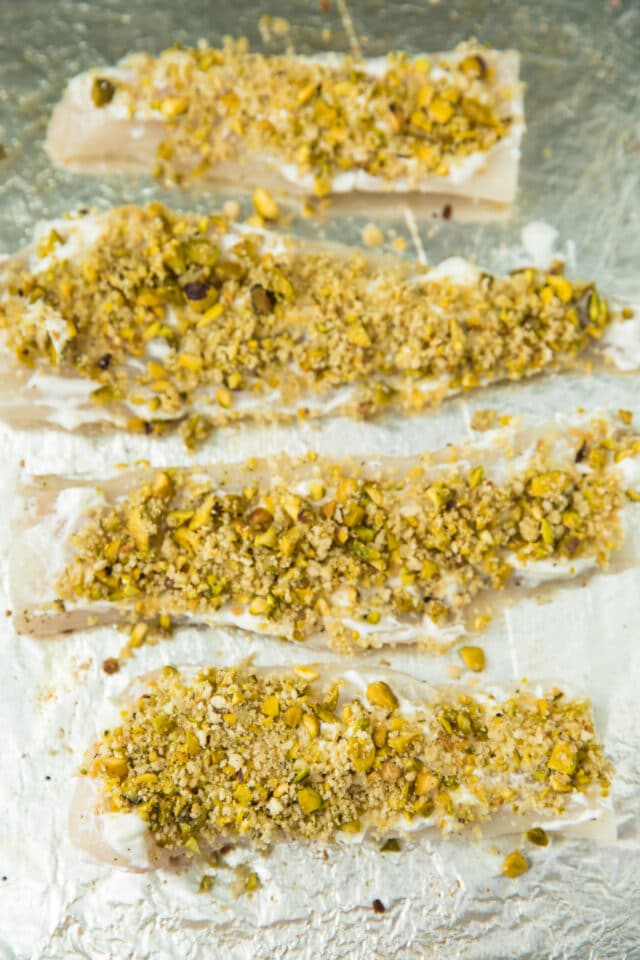 Healthy Pistachio Crusted White Fish on a sheet pan ready for baking