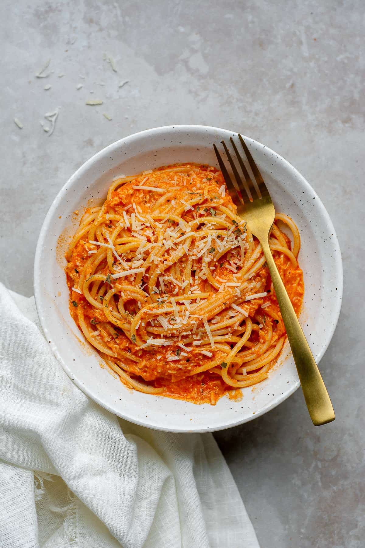 Roasted red pepper sauce over pasta with parmesan sauce.