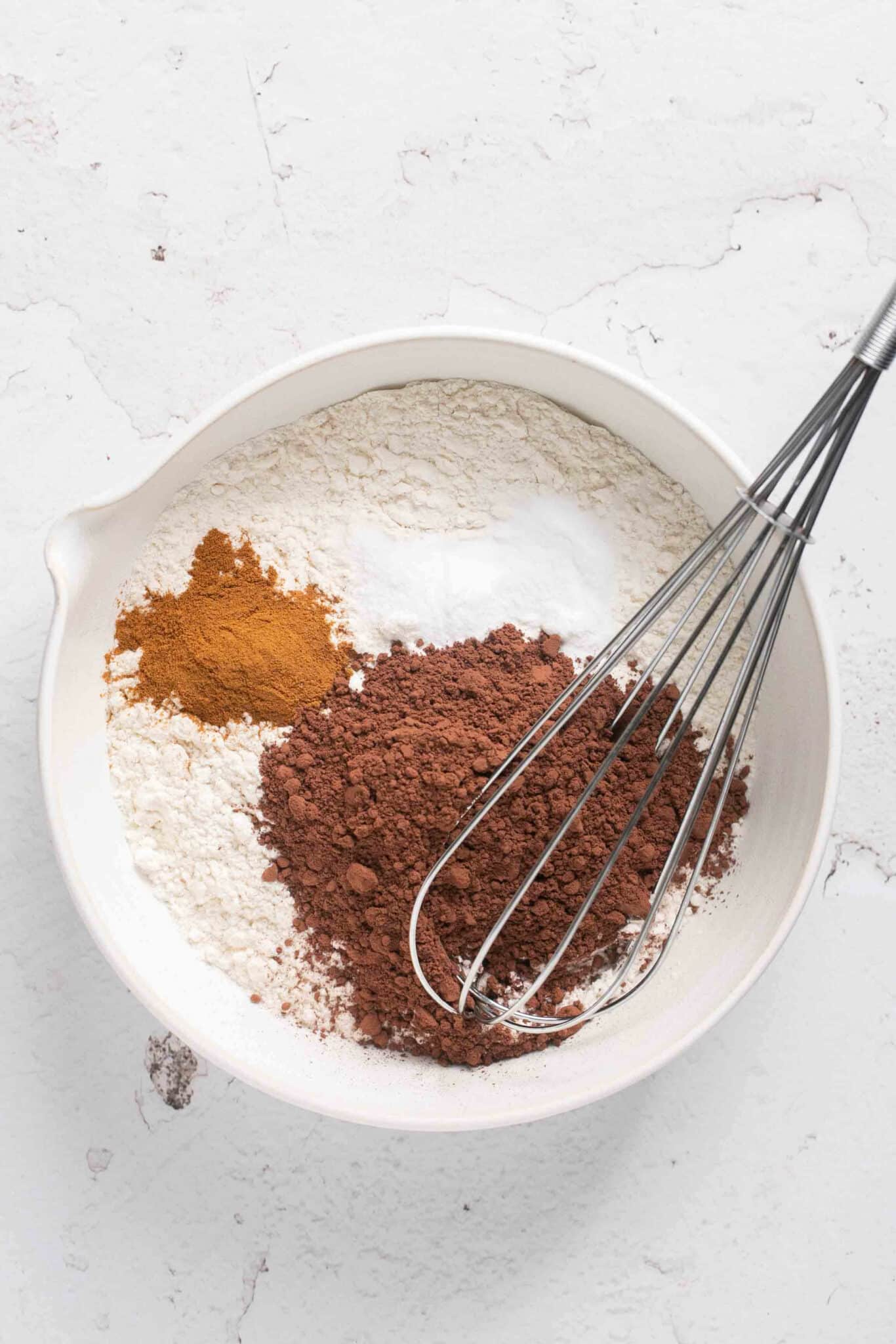Whisking flour with cocoa powder and cinnamon.