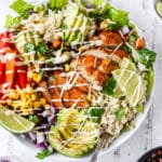 burrito bowls topped with chicken, avocado and dressing