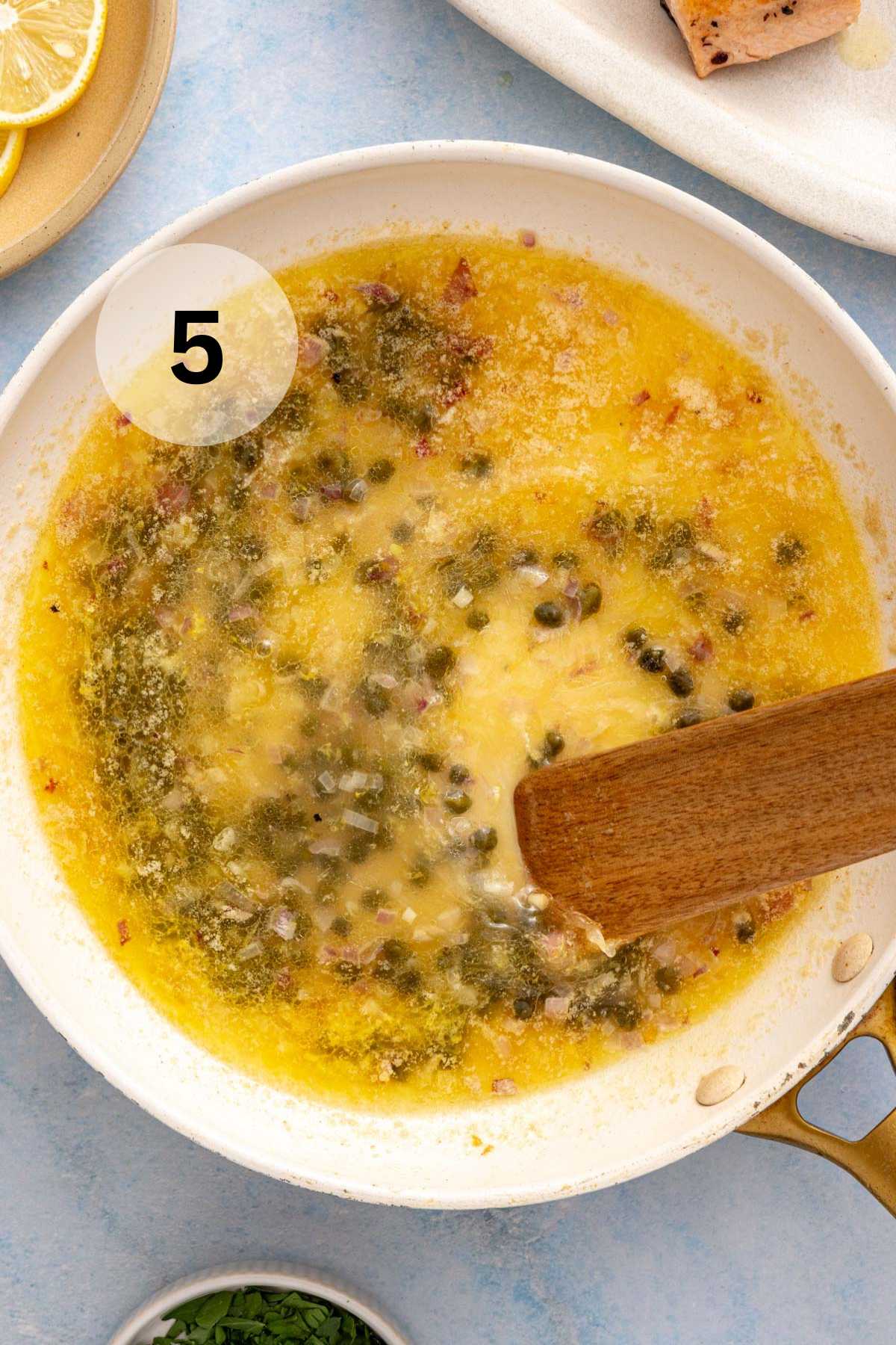 Stirring capers with lemon juice, broth and butter.