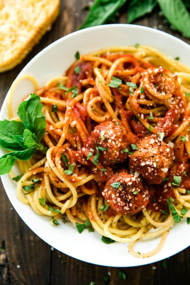 close up of the best EVER Spaghetti and Meatballs recipe on a white plate