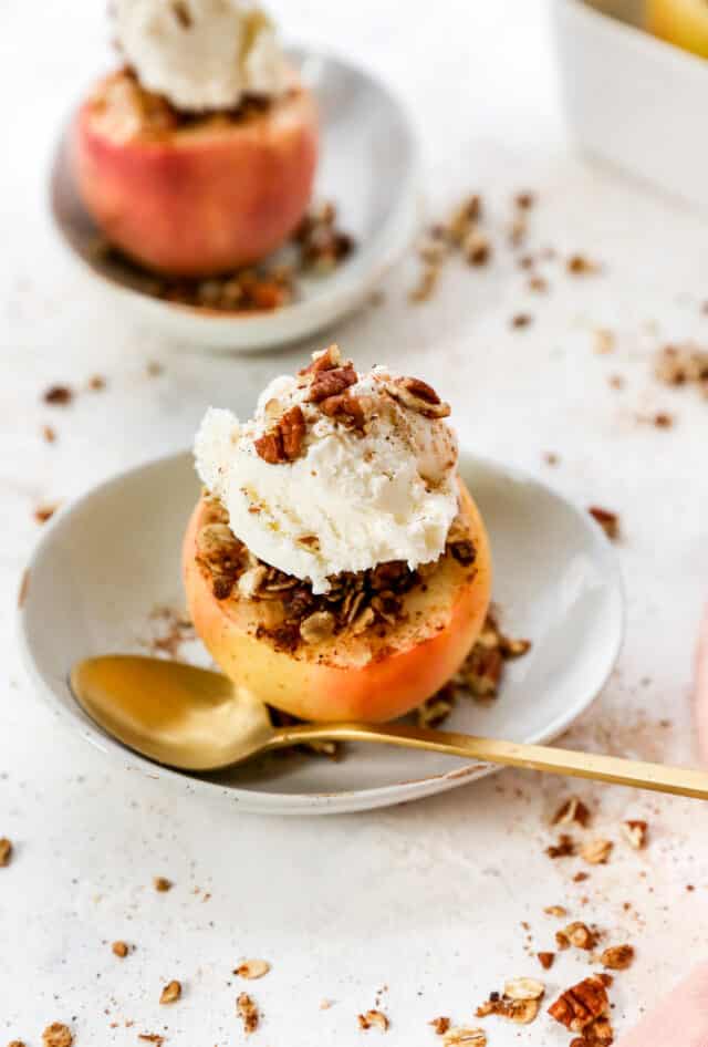 baked apples stuffed with apple crisp filling and topped with vanilla ice cream