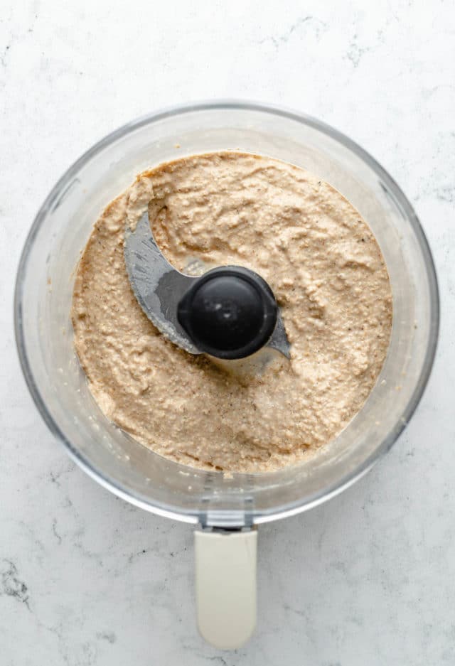 mixing ingredients in a food processor for oat flour pizza crust