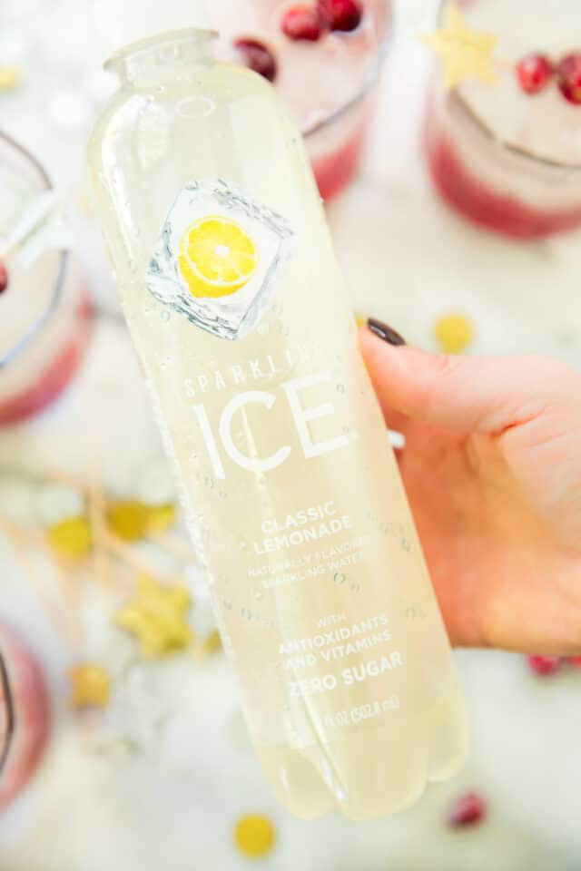 woman's hand holding Sparkling Ice Classic Lemonade bottle