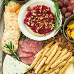 holiday cheese board with cranberry sauce baked brie