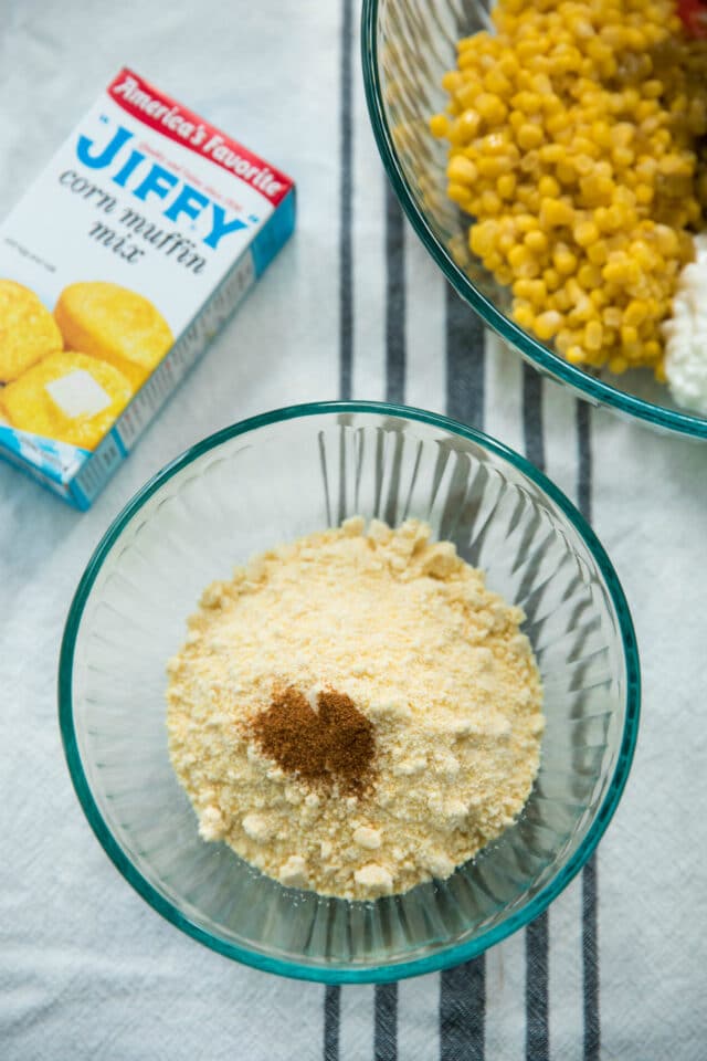 cornbread muffin mix with other dry cornbread ingredients in a glass bowl