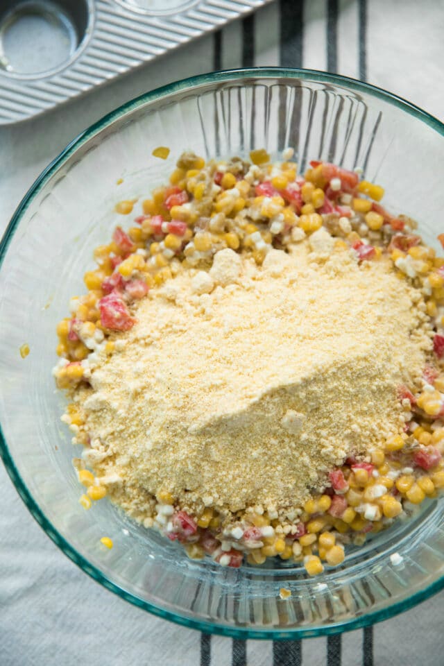 all cornbread muffin mix ingredients in a glass mixing bowl