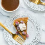 healthy pumpkin pie on a white plate with a gold fork served with coffee