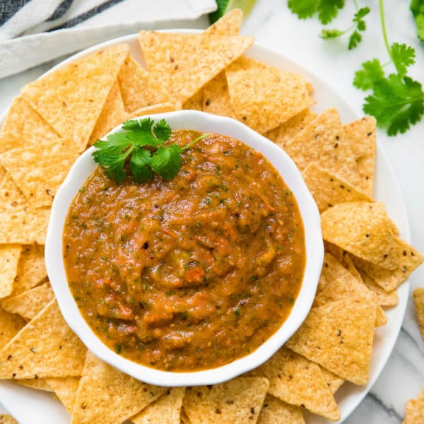 roasted salsa served in a white bowl with tortilla chips
