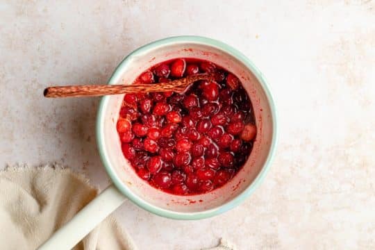 cooking cranberry sauce in a small pot