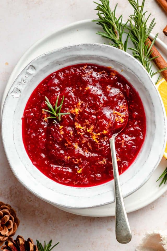 fresh cranberry sauce in a white bowl with a spoon