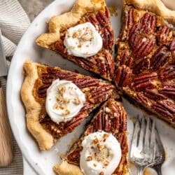 Pecan pie without corn syrup topped with whipped cream.