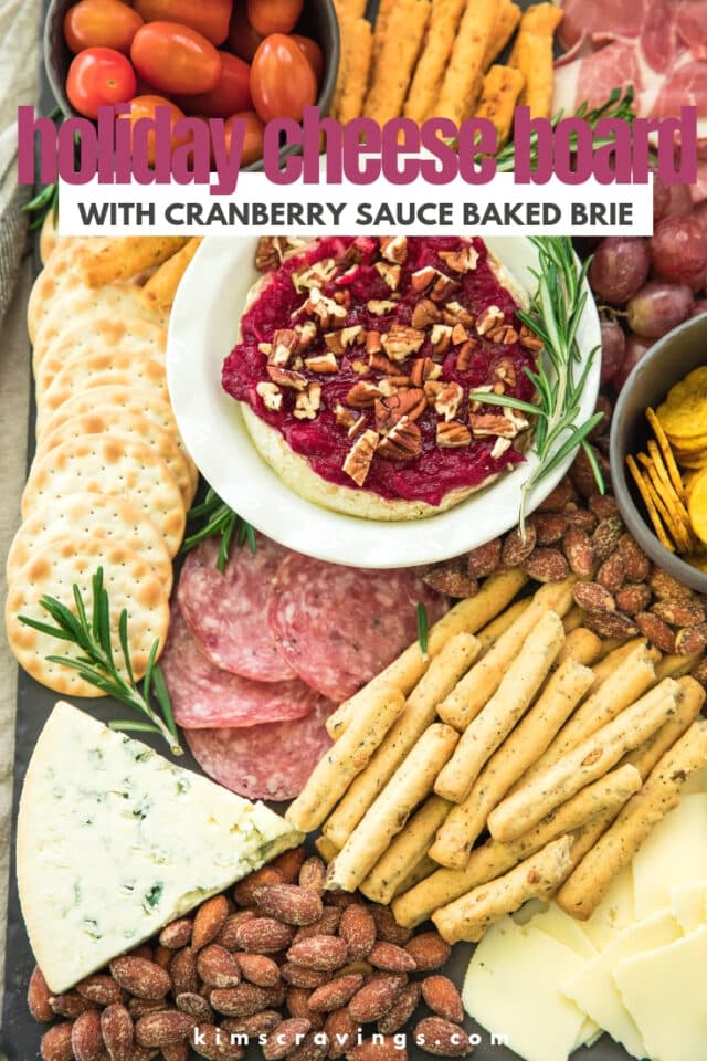 cheese board filled with meats, crackers, cheeses and cranberry sauce brie