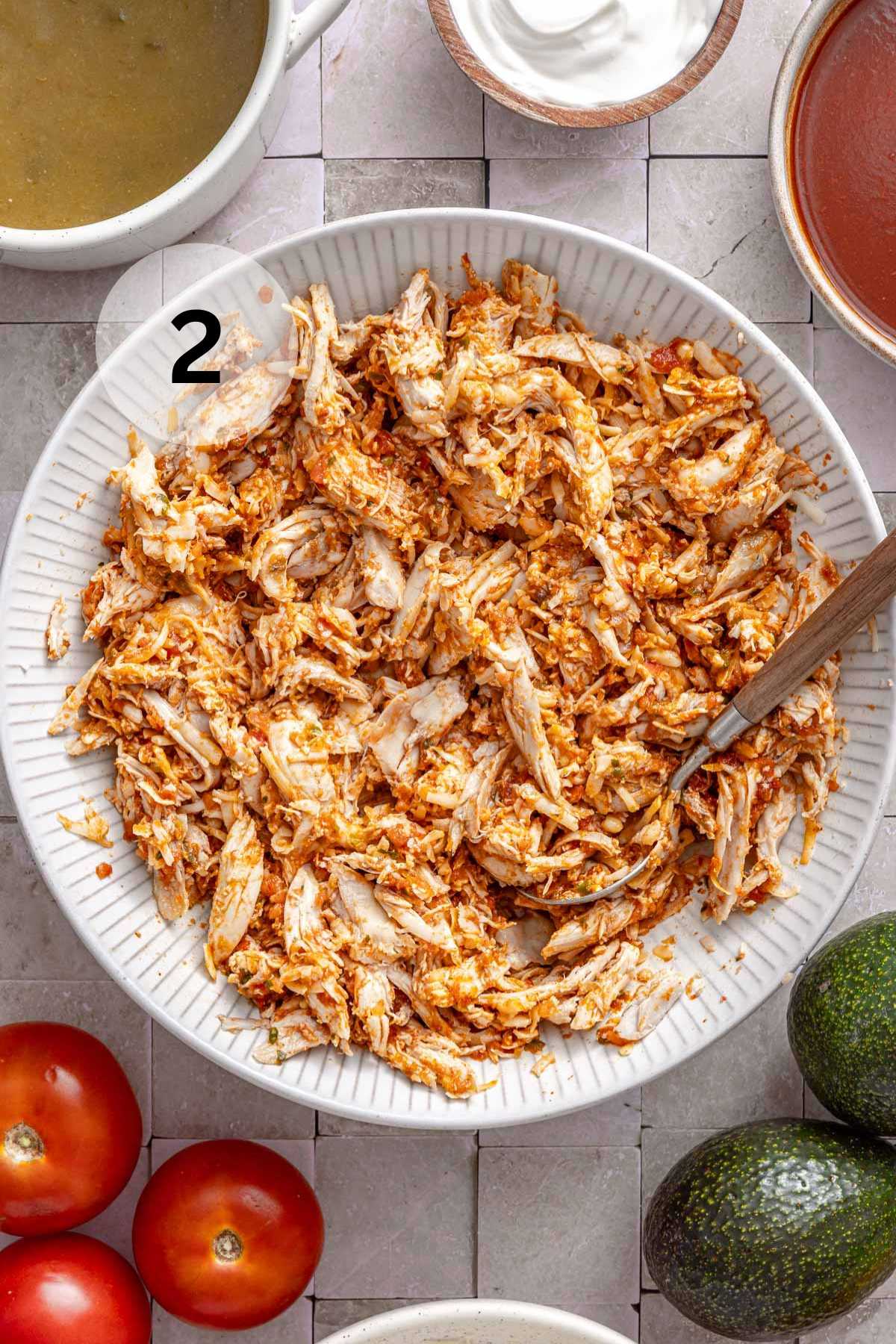 Stirring shredded chicken with salsa and taco seasoning.