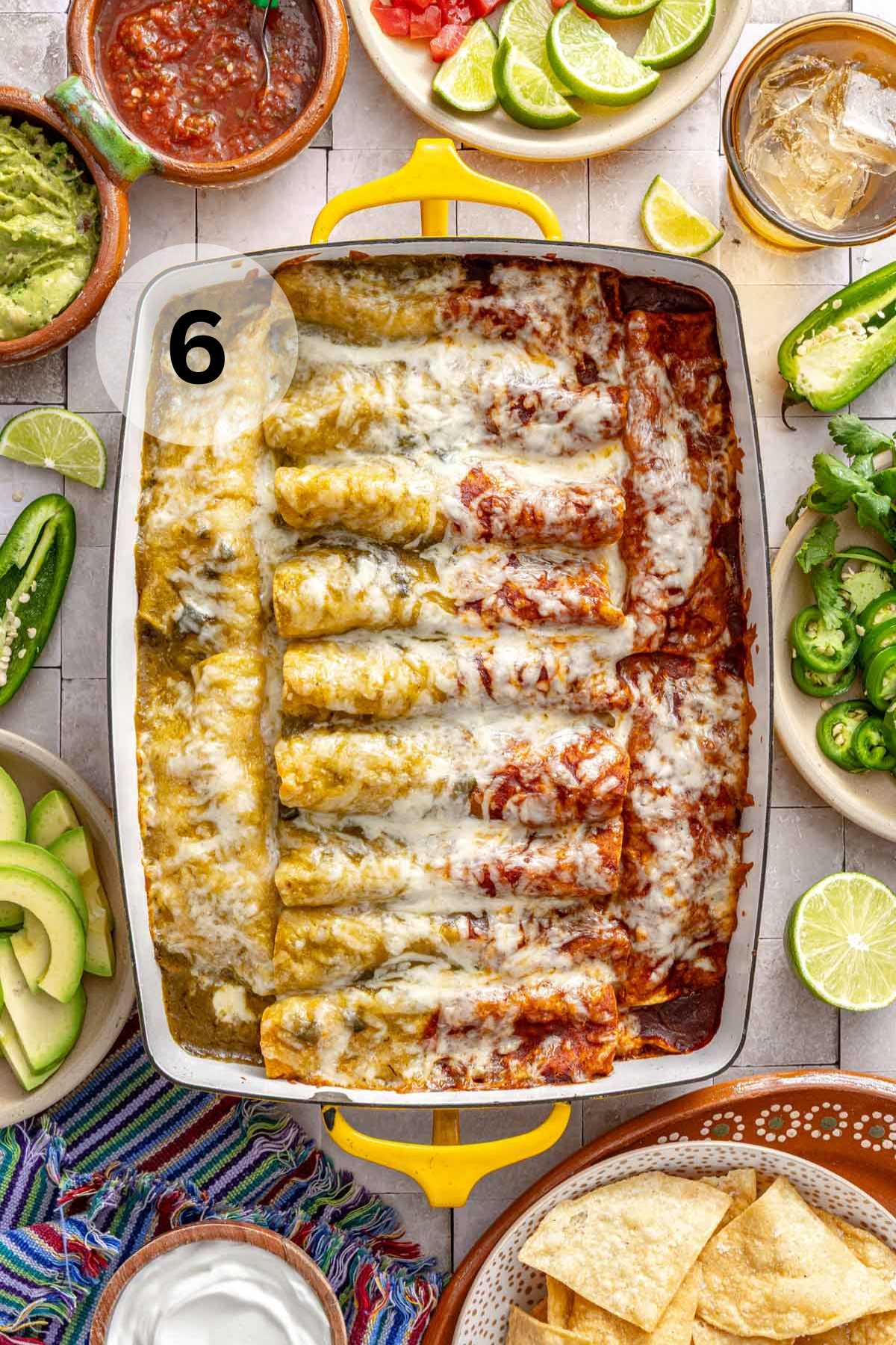 Baked enchiladas with red and green sauce on top.