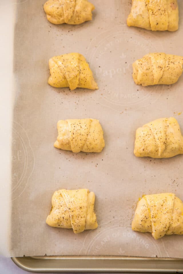 crescent rolls on a baking sheet ready to go in the oven